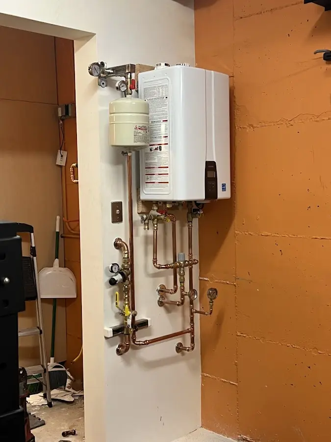 Plumbing technician inspecting water heater connections in Ridgefield Park village